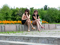 No matter that these two chicks in jeans skirts are sitting with their legs crossed we still managed catch their upskirts on camera!